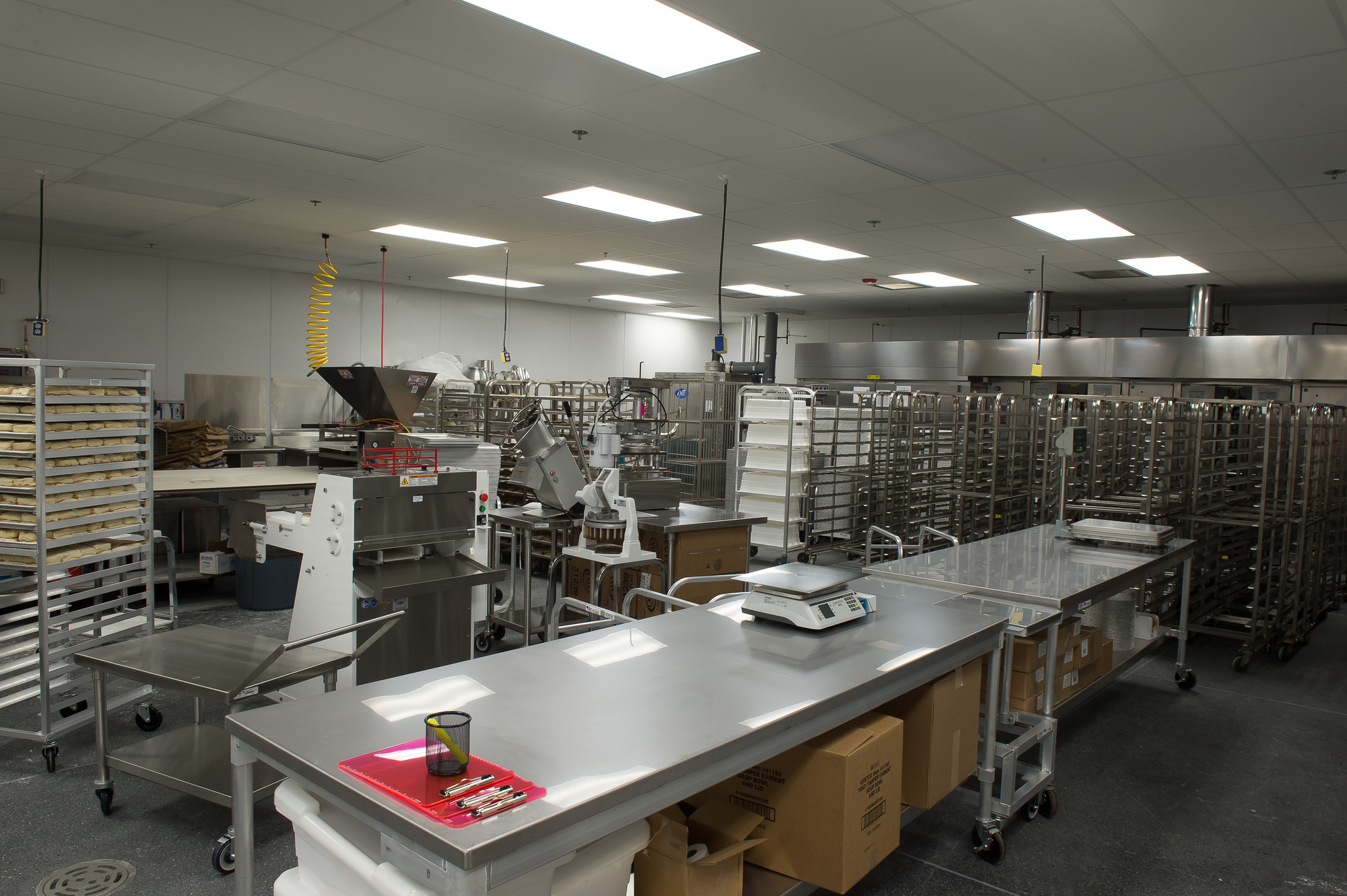 An industrial kitchen in Bellingham requires expert electrician services to maintain its bright fluorescent lighting and ensure optimal performance of equipment like scales and metal tables. If you're in Vancouver, WA, our electricians are ready to assist with similar needs to ensure efficiency and functionality in your space.