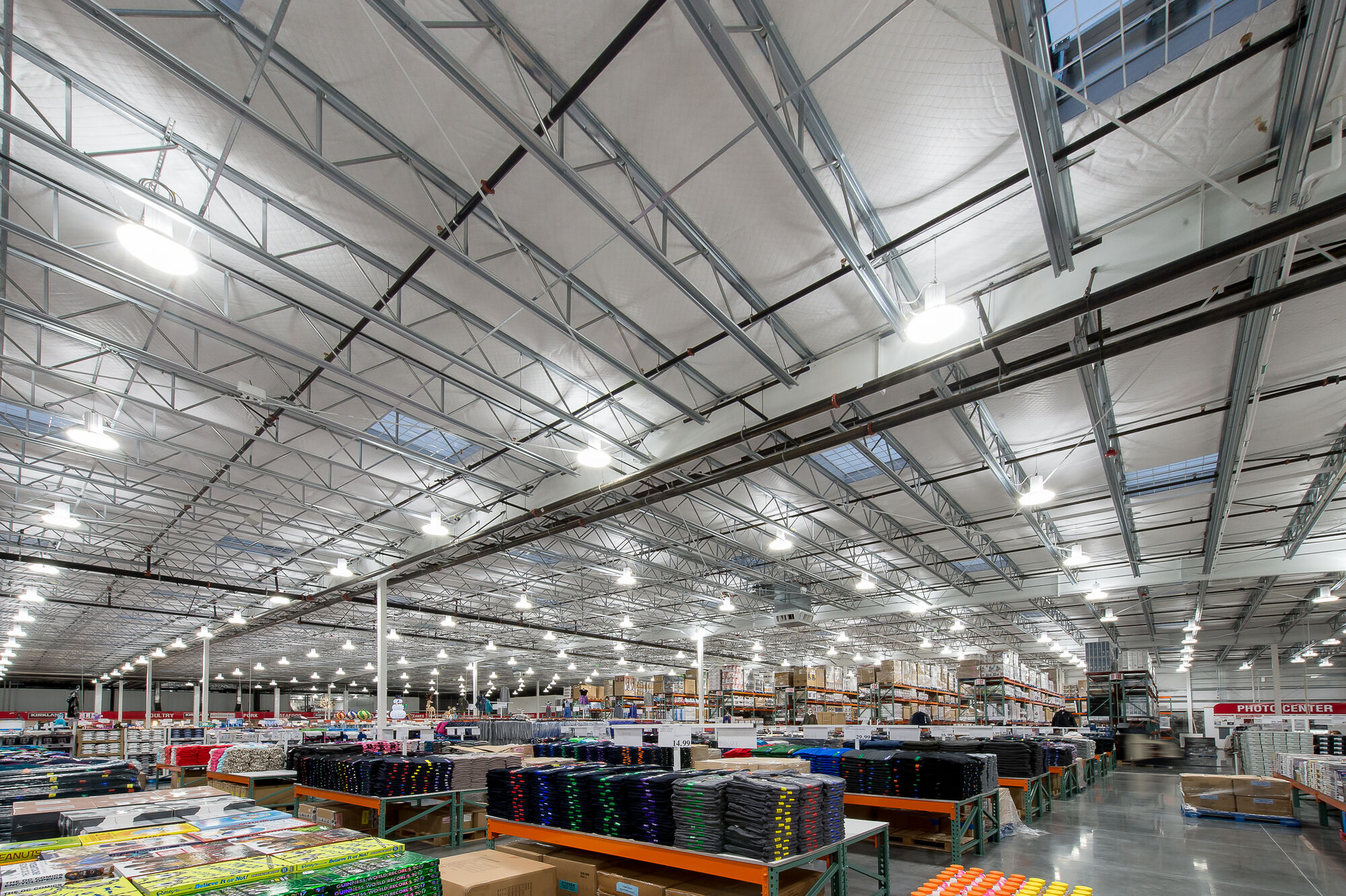 The interior of the Bellingham Costco Warehouse features high ceilings and bright lighting, ideal for showcasing stocked shelves of bulk items. For professional electrician services to ensure optimal lighting in similar commercial spaces in Vancouver, WA, contact our team.