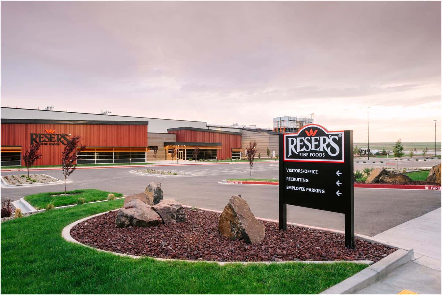 Reser Fine Foods features a distinct red and brown exterior. A clear sign directs visitors to the office, recruiting center, and employee parking areas. If you require electrician services for outdoor lighting or signage installation at similar locations, our team in Vancouver is ready to assist.