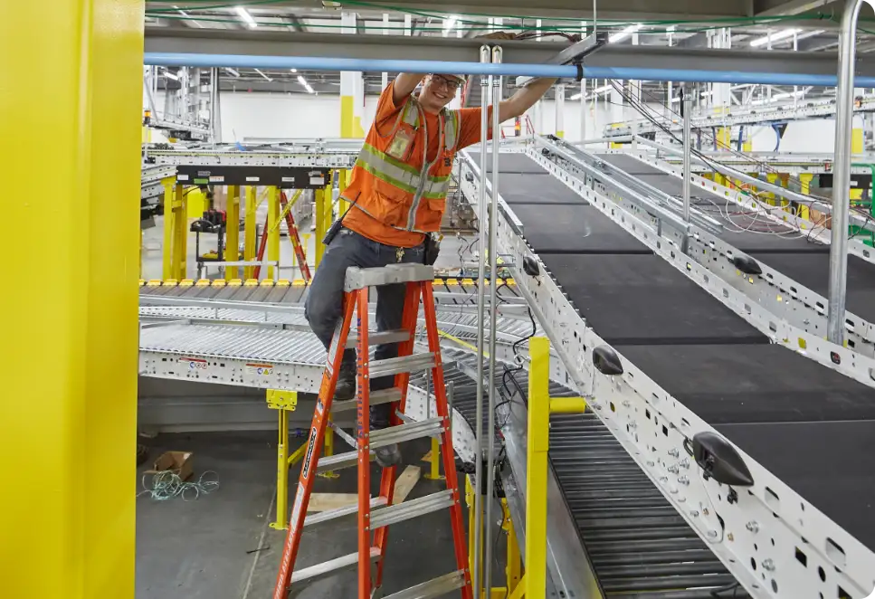 Prairie Electric electrician working on repairing a conveyor belt